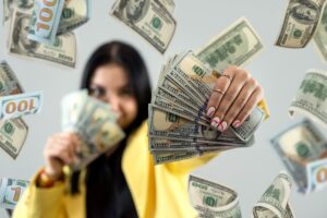 Happy landlord holding a large amount of cash, representing strong rental income and profitable property returns