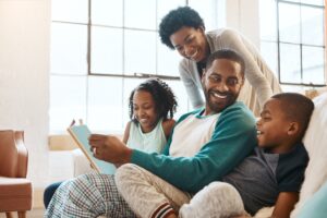 family with story on sofa for bonding together on fathers day at home